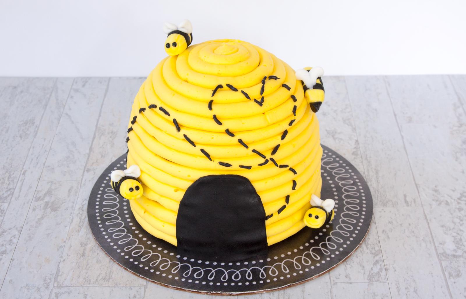 Yellow beehive cake with piped bees