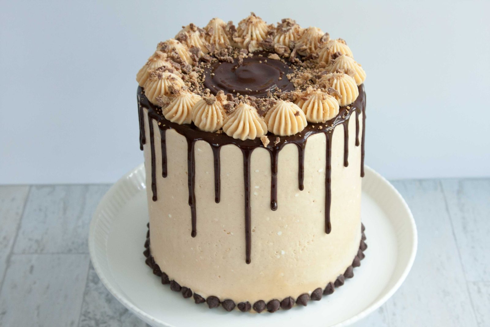 Chocolate drip cake with piped buttercream swirls